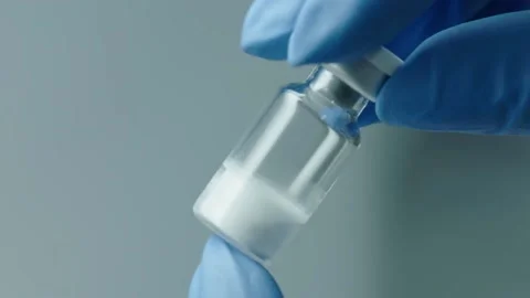 The doctor picks up a vials of medicine or vaccine Stock Footage 153474953