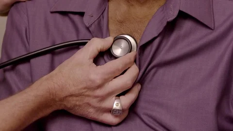 Doctor placing stethoscope on patient's chest Stock Footage