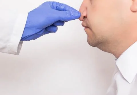 Doctor plastic surgeon checks a man s nose before surgery for nose correction Stock Photos