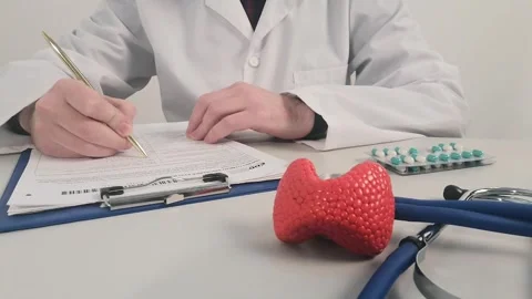 Doctor pointing on model of thyroid gland and give pills. Protection, treatment Stock Footage 261392852