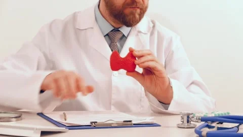 Doctor pointing on model of thyroid gland and give pills. Protection, treatment Stock Footage 261392879