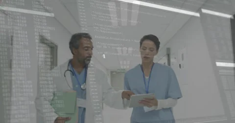 Doctor pointing nurse tablet screen initiating patient care data review with Video stock 312771204