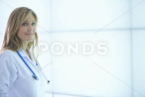 Doctor Posing Against Backlit Wall Panel