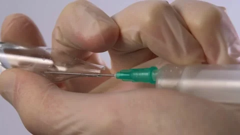 Doctor prepares a syringe for an injection Stock Footage 265017938