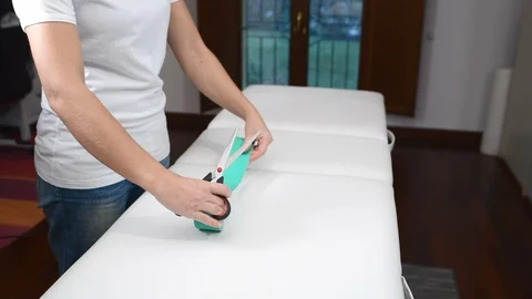 Doctor prepares the tape before application Stock Footage 99340516