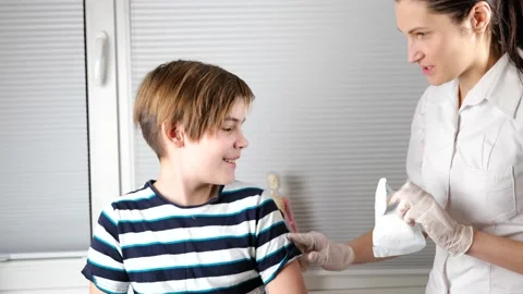Doctor preparing to do injection to boy arm Stock Footage 147211186