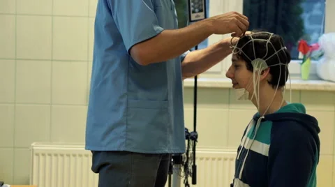 Doctor preparing kid for brain scan in hospital  HD Stock Footage 44410679