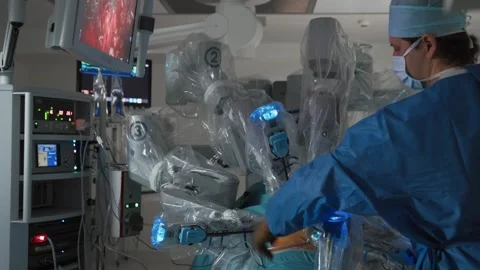 Doctor preparing patient for surgery using advanced medical robotic equipment Stock Footage 245620121