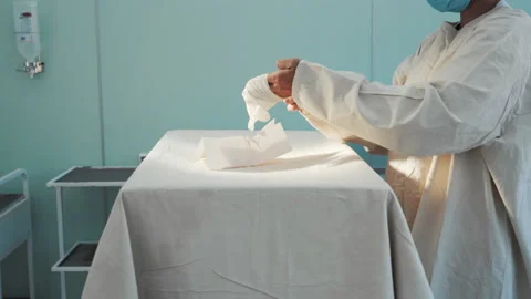 Doctor preparing for surgery in operating room, putting on rubber latex gloves Video stock 201471811