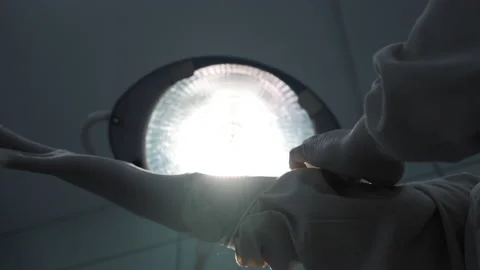 Doctor preparing for surgery in operating room, putting on rubber latex gloves Stock Footage 201524340