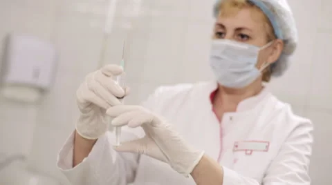 Doctor preparing a syringe for injection. Stock Footage 67974595