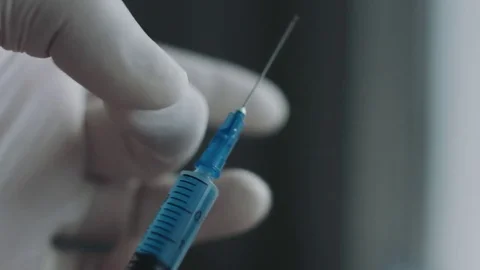 Doctor preparing a syringe for injection Stock Footage 70524793