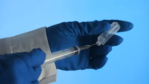 The doctor is preparing a syringe for injection Stock Footage 105086217