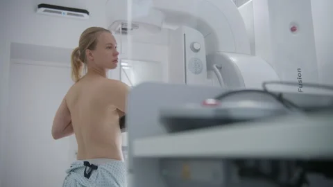 Doctor presses button to launch mammogram machine Stock Footage 251910796