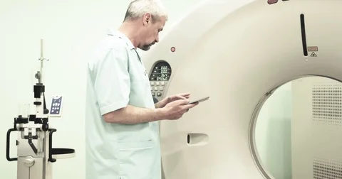 Doctor presses settings button of CT MRI scanner 4k video. Medical equipment Stock Footage 69795009