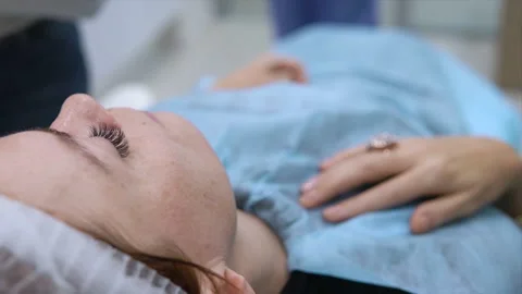 Doctor processes needle and face of girl before procedure. Beautician makes Stock-Footage 144334581