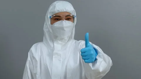 Doctor in protective PPE suit doing thump up hand sign Video stock 166905830