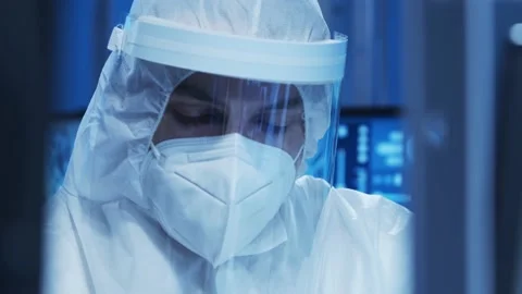 Doctor in protective suit is doing a science experiments and developing vaccine Video stock 155699897