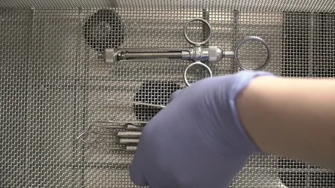 The doctor pulls on dental instruments cleaned in the thermodisinfector Stock Footage 104508928