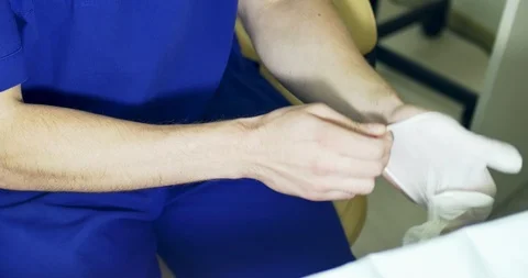 Doctor put on white latex gloves Stock Footage 96001069