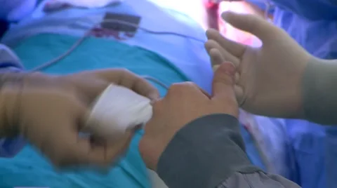 Doctor puting gloves on Stock Footage 43052007