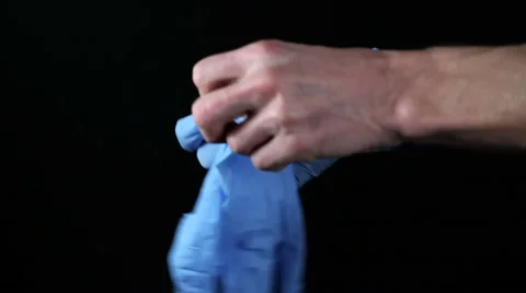 The doctor puts on disposable gloves Stock Footage 57653530