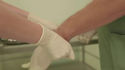 Doctor puts on gloves Stock Footage 82348596