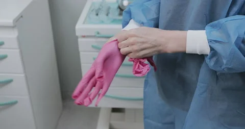 Doctor puts on gloves Stock Footage 136460818