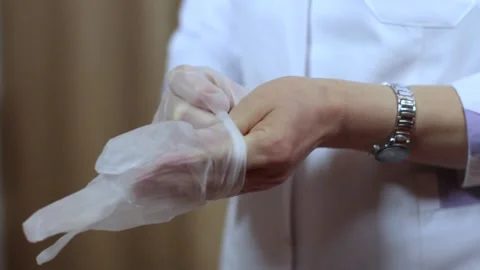 Doctor Puts On Gloves Before Operation Stock Footage 233858539