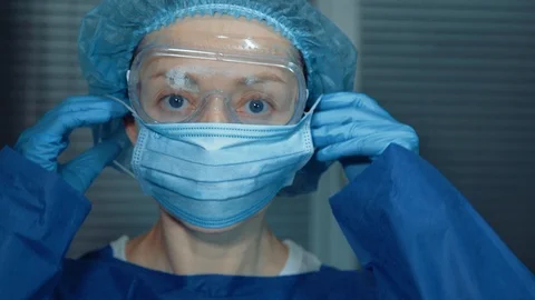 The doctor puts on a protective mask Stock Footage 126172178