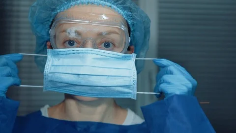 The doctor puts on a protective mask Stock Footage 126172260