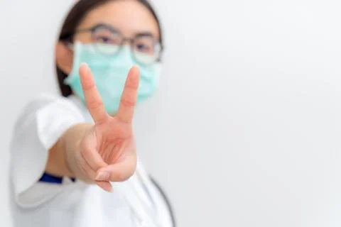 Doctor raise two V shape finger Stock Photos
