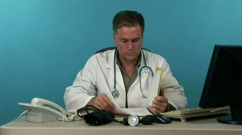 Doctor reading folder smiles at camera Stock Footage 290312