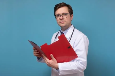 Doctor reading some notes trying to make a correct diagnosis on data Stock Photos