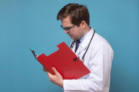 Doctor reading some notes trying to make a correct diagnosis on data Stock Photos