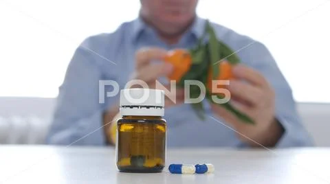 Doctor Replacing Medicament Abuse with Fresh Fruits Vitamins Consume Stock Photos