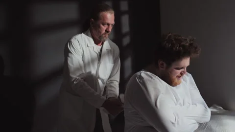 Doctor Restraining Patient With Use Of Straitjacket Stock Footage 252068779