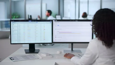 Doctor Reviewing Patient Data On Computer Stock Footage 340405738