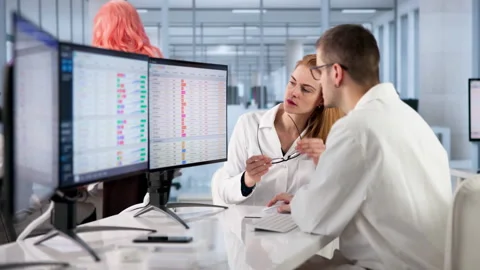 Doctor Reviews Medical Data On Computer Screen Stock Footage 333841368