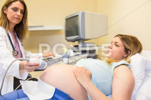 Doctor Scanning Pregnant Patient's Belly