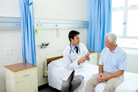 Doctor, senior man patient and speaking with advice, explain or listen to news Stock Photos