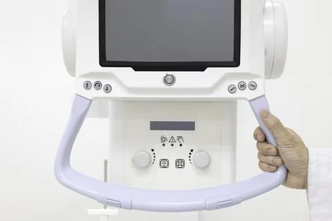 A doctor setting up a x-ray machine. Stock Photos