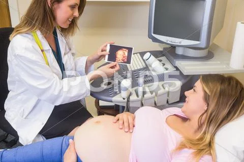 Doctor Showing Picture To The Pregnant Woman