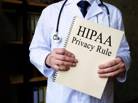The doctor shows HIPAA privacy rule in his office. Stock Photos