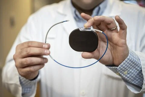 A doctor shows a pacemaker Stock Photos