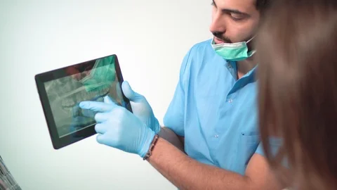 Doctor Shows Teeth X-ray on Tablet Stock Footage 87323689