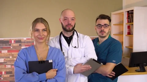 Doctor shows thumb up while standing next to hospital team doctors Stock Footage 75680051