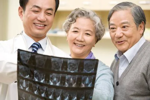 Doctor Shows an X-Ray Test Results to Senior Couple Stock Photos