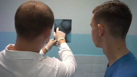 Doctor shows x-rays of the patient Video stock 77203854