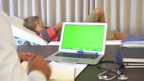 Doctor Sits At The Computer With A Green Screen 動画素材 96673215